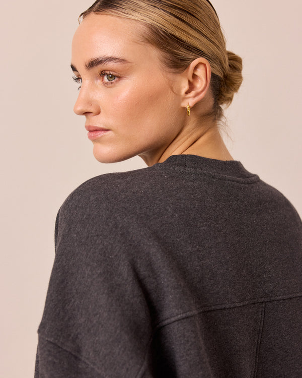 model wears eden charcoal marl fleeceback jersey jumper