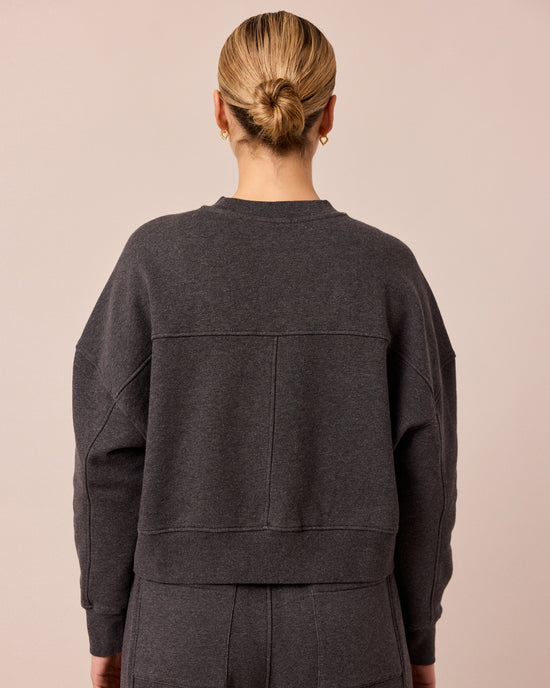 model wears eden charcoal marl fleeceback jersey jumper