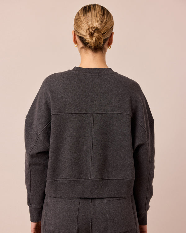model wears eden charcoal marl fleeceback jersey jumper