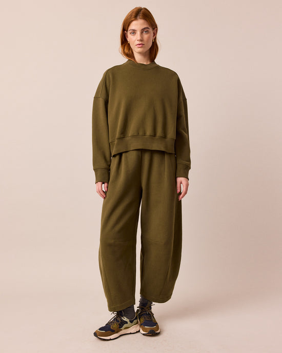 model wears eden earth green jersey jumper