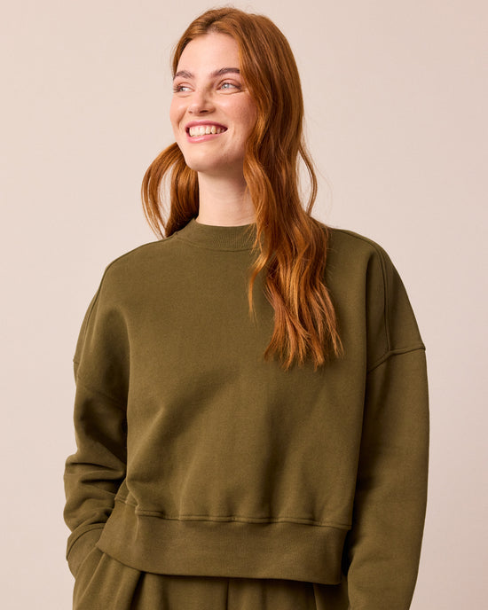 model wears eden earth green jersey jumper