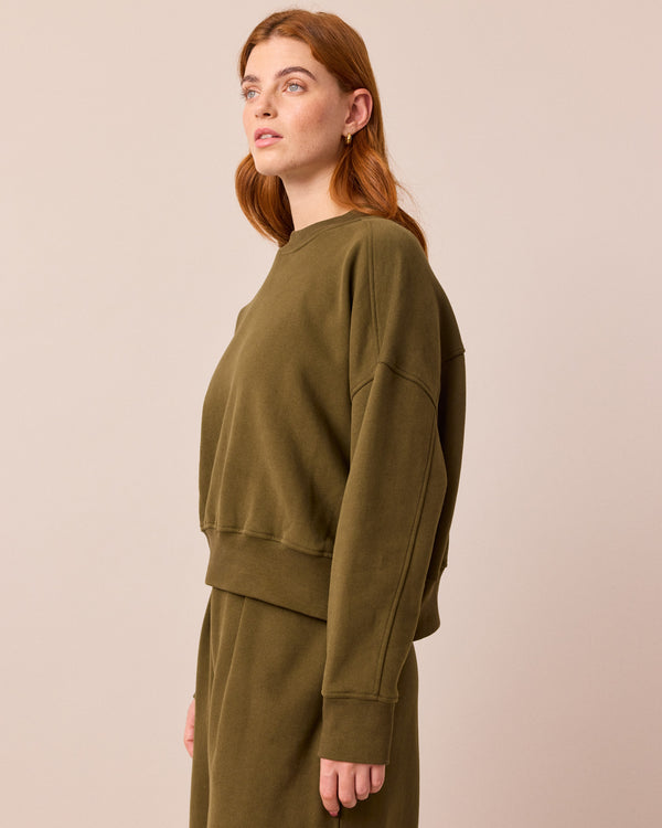 model wears eden earth green jersey jumper