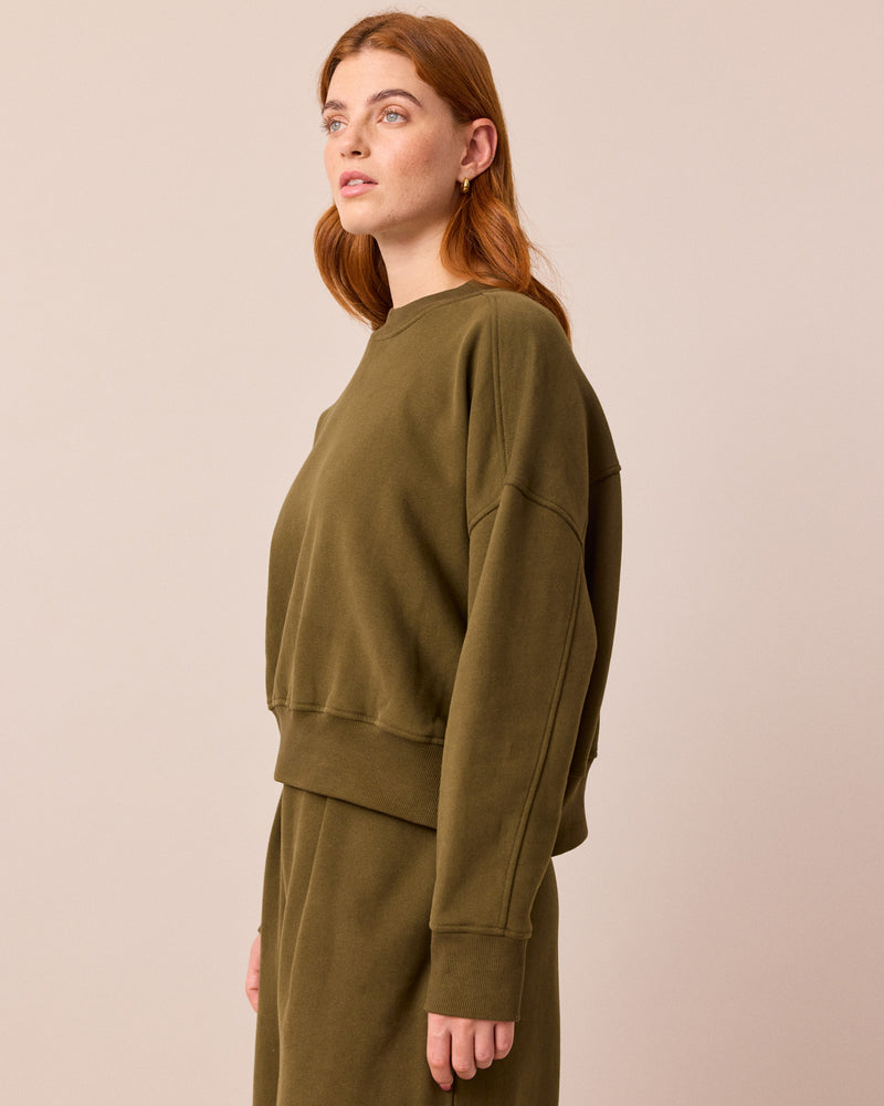 model wears eden earth green jersey jumper