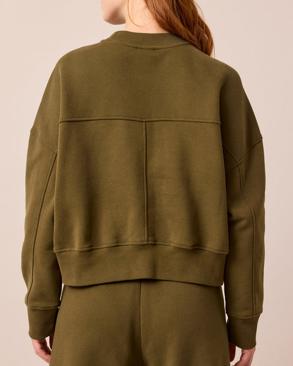 model wears eden earth green jersey jumper