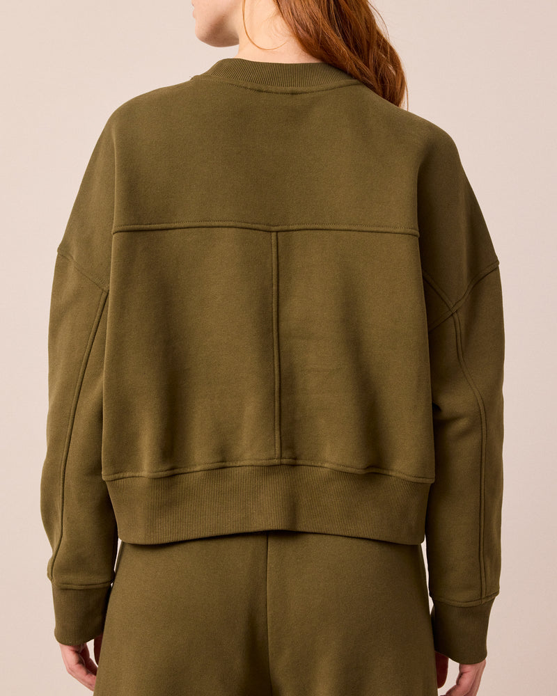 model wears eden earth green jersey jumper