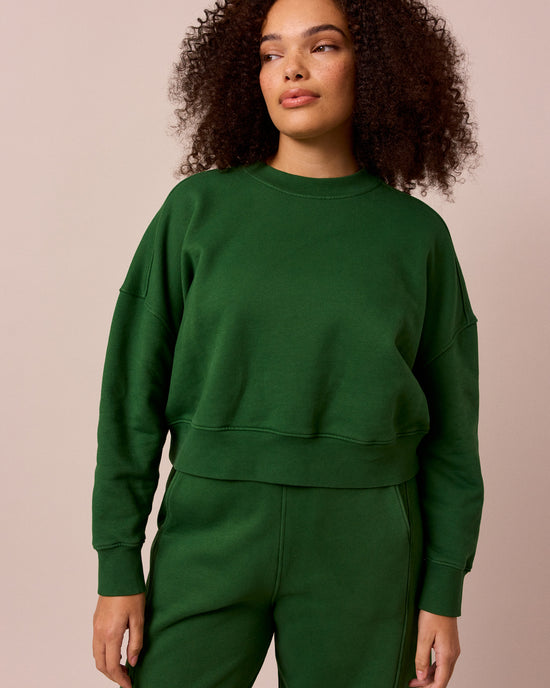model wears eden verdant green fleeceback jersey jumper