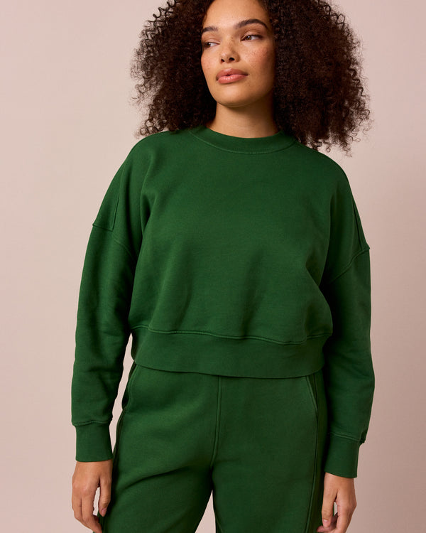 model wears eden verdant green fleeceback jersey jumper