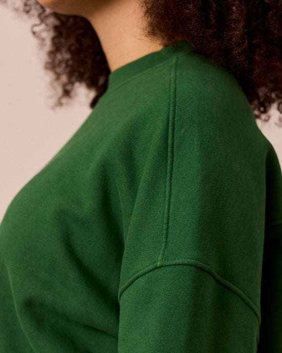 model wears eden verdant green fleeceback jersey jumper