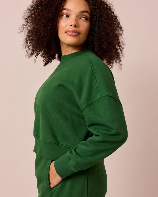model wears eden verdant green fleeceback jersey jumper