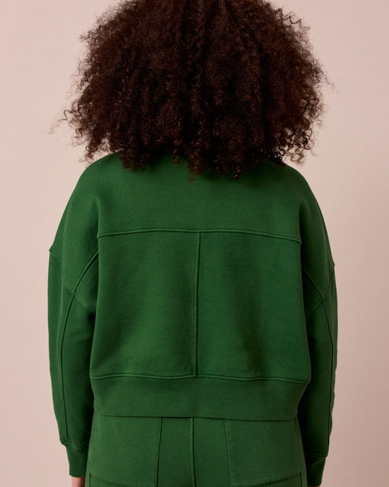 model wears eden verdant green fleeceback jersey jumper