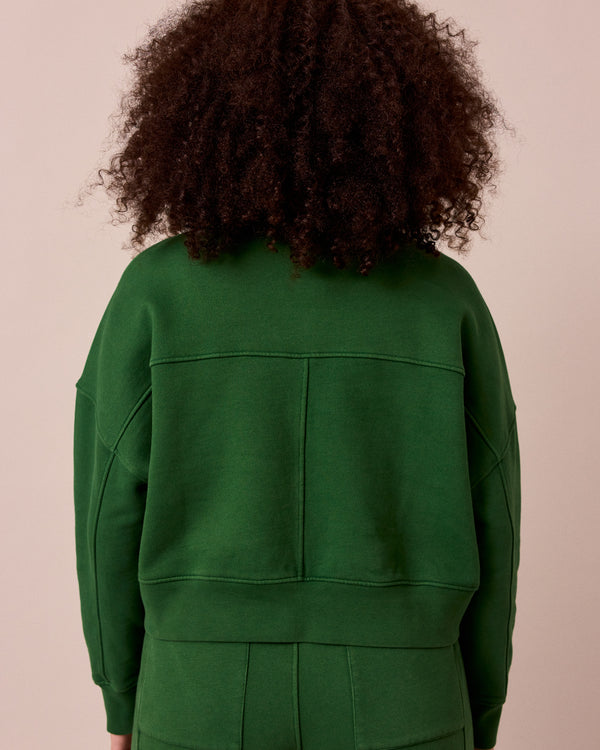 model wears eden verdant green fleeceback jersey jumper