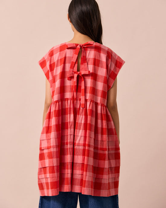 model wears ella pink lemonade cotton linen dress