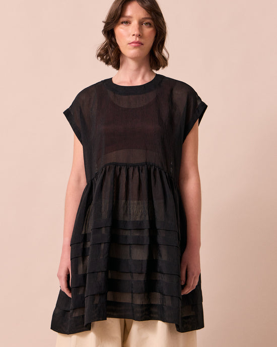 model wears ella black sheer stripe dress