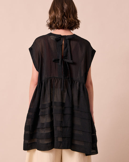 model wears ella black sheer stripe dress