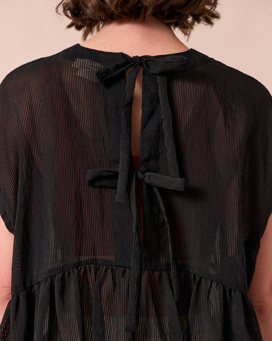 model wears ella black sheer stripe dress
