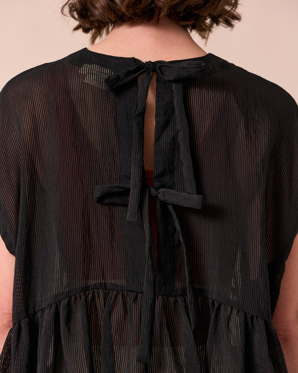 model wears ella black sheer stripe dress