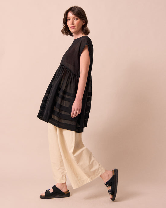 model wears ella black sheer stripe dress