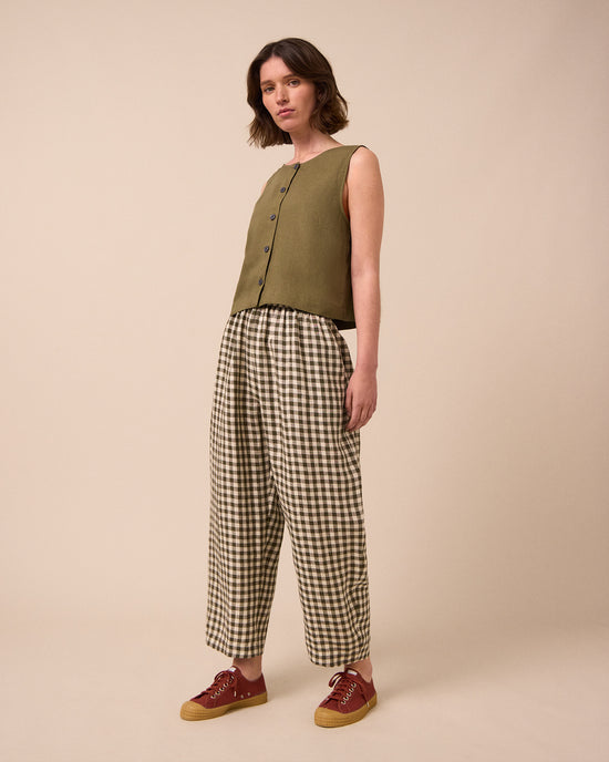 model wears mabel olive gingham linen trousers right