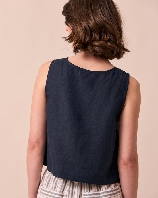 model wears elodie navy linen top