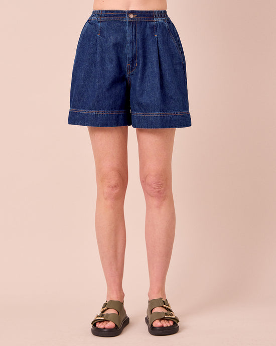 model wears ember mid blue denim shorts