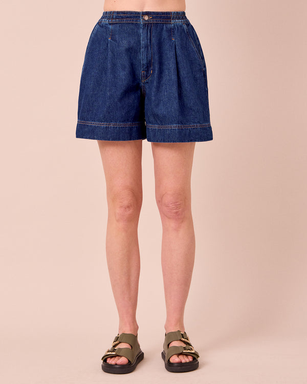 model wears ember mid blue denim shorts
