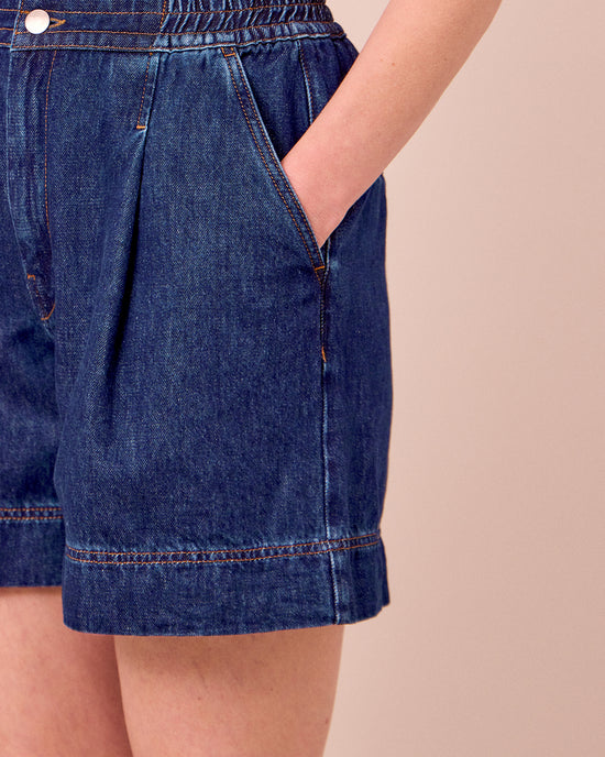 model wears ember mid blue denim shorts