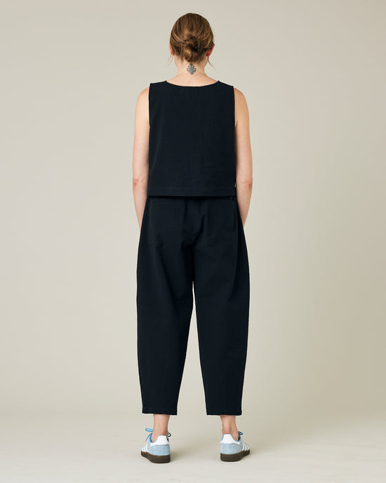 model wears black seersucker huxley trousers