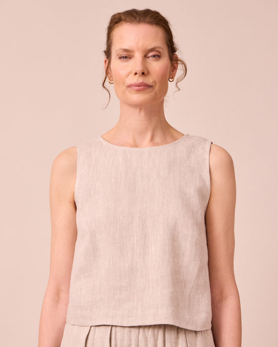 model wears esme natural linen top