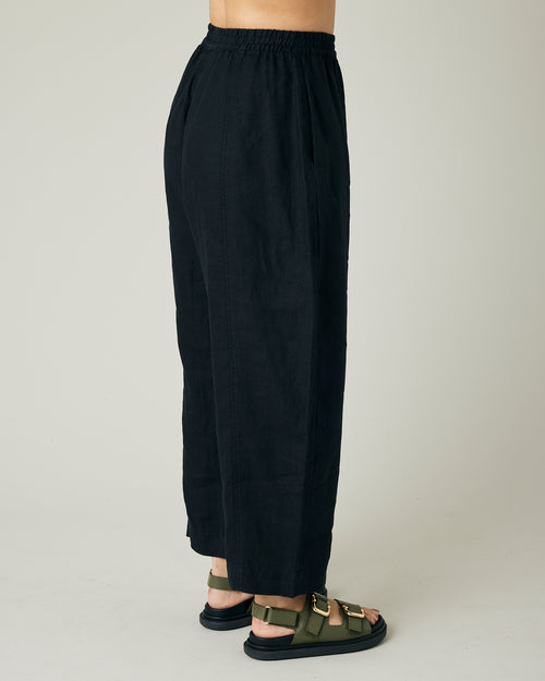 model wears black linen mabel trousers to the right