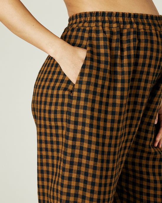 pregnant model wears rust gingham linen mabel trousers