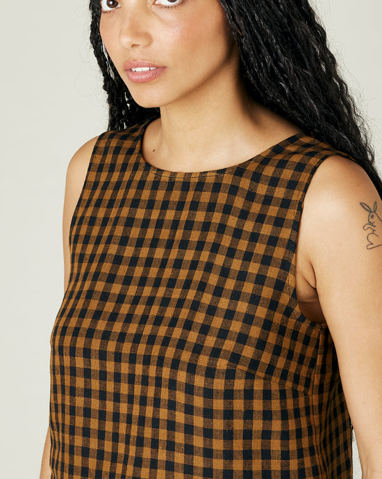 model wears rust gingham linen esme top