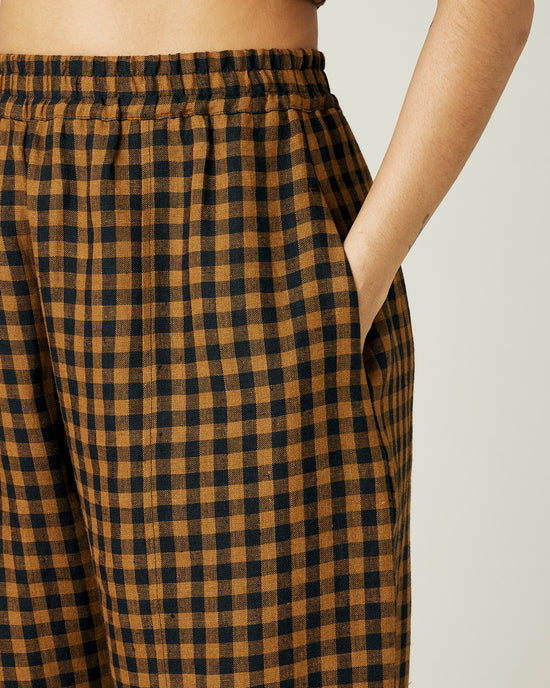 model wears rust gingham linen mabel trousers