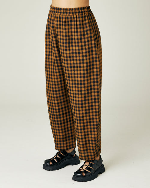 model wears rust gingham linen mabel trousers left