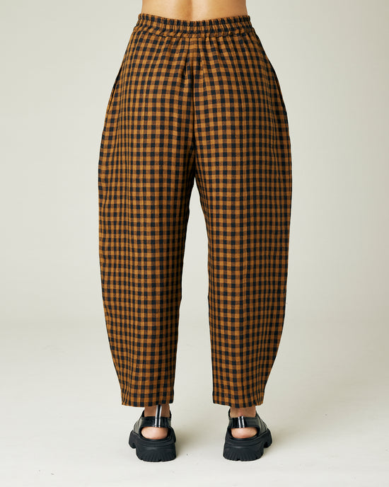 model wears rust gingham linen mabel trousers back