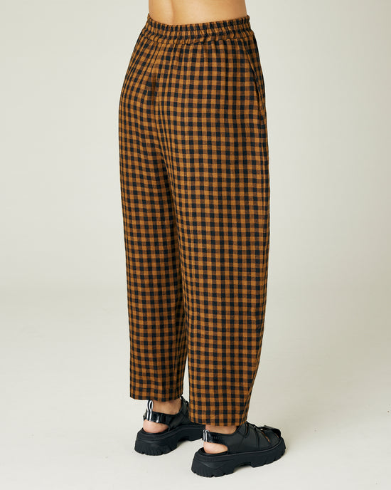 model wears rust gingham linen mabel trousers right