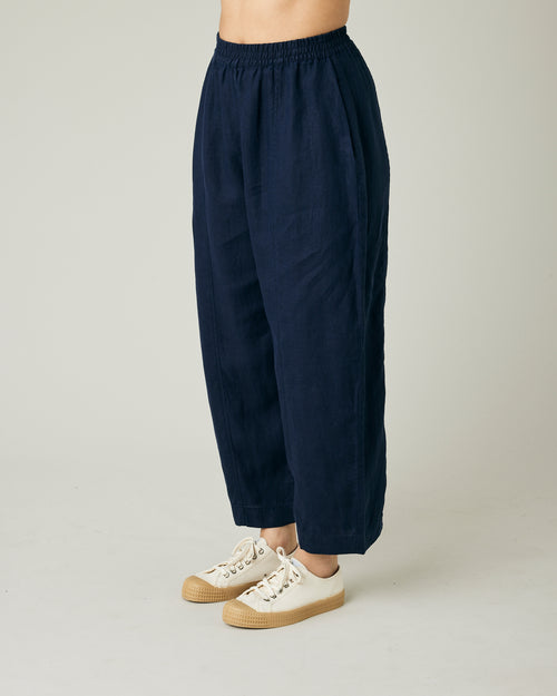 model wears navy linen mabel trousers to the left side