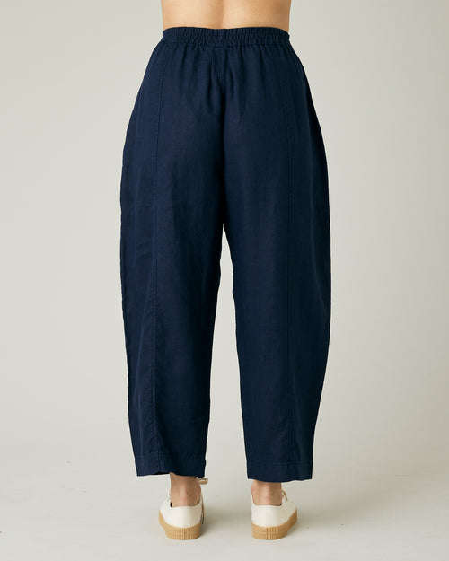 model wears navy linen mabel trousers to the back