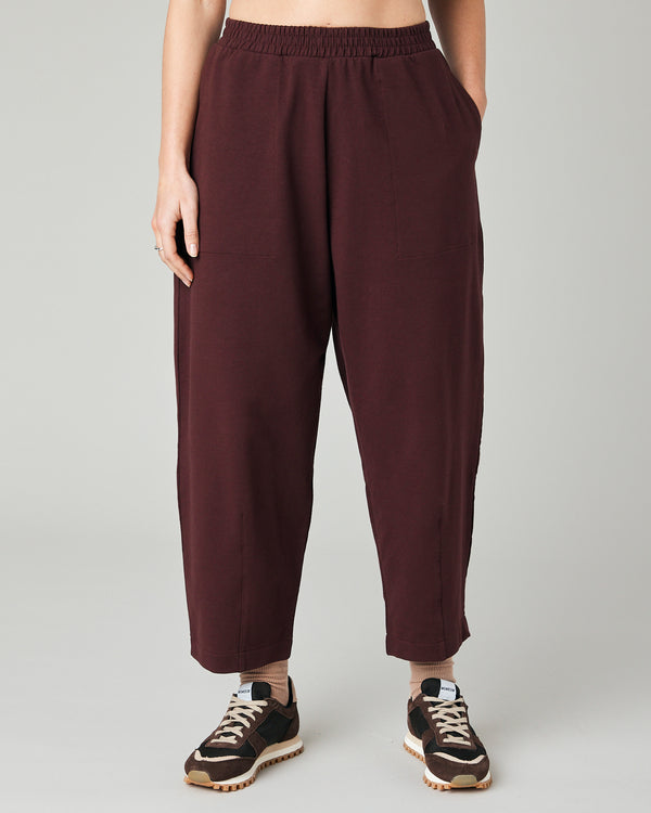 model wears burgundy huxley jersey trousers front