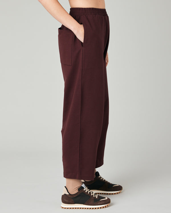 model wears burgundy huxley jersey trousers right