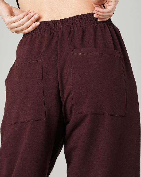 model wears burgundy huxley jersey trousers