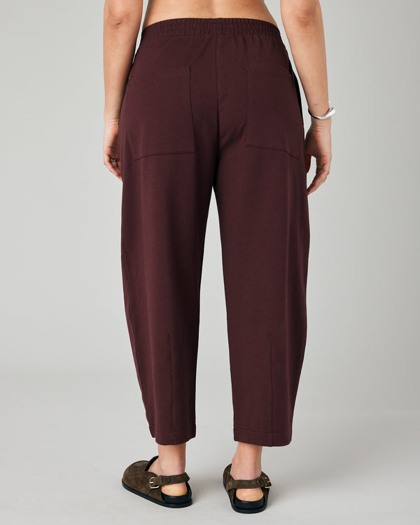 pregnant model wears burgundy huxley jersey trousers