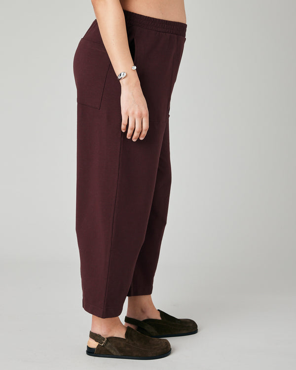 pregnant model wears burgundy huxley jersey trousers