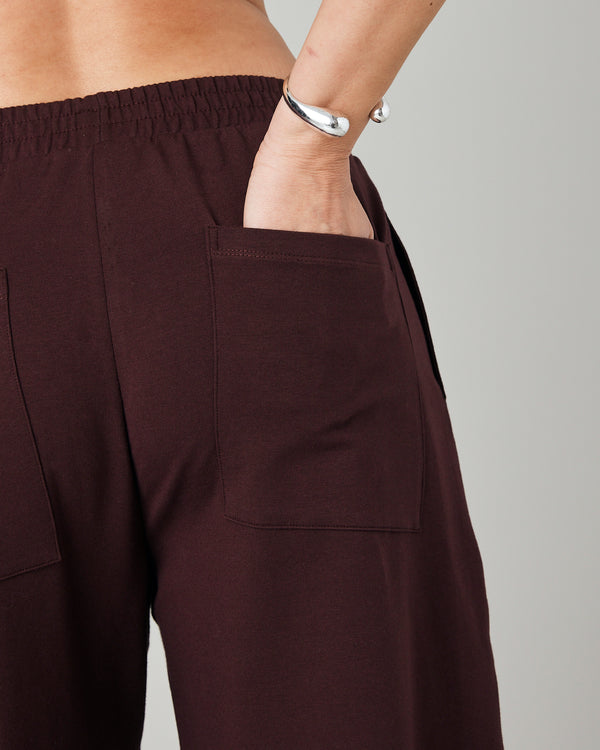 pregnant model wears burgundy huxley jersey trousers