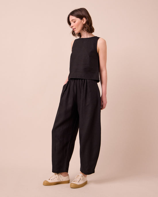 model wears daisy black linen trousers right
