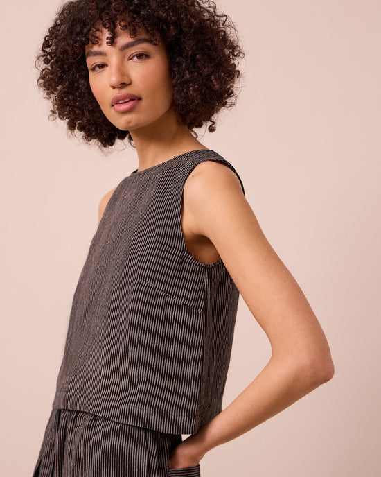 model wears esme black and ecru stripe linen top