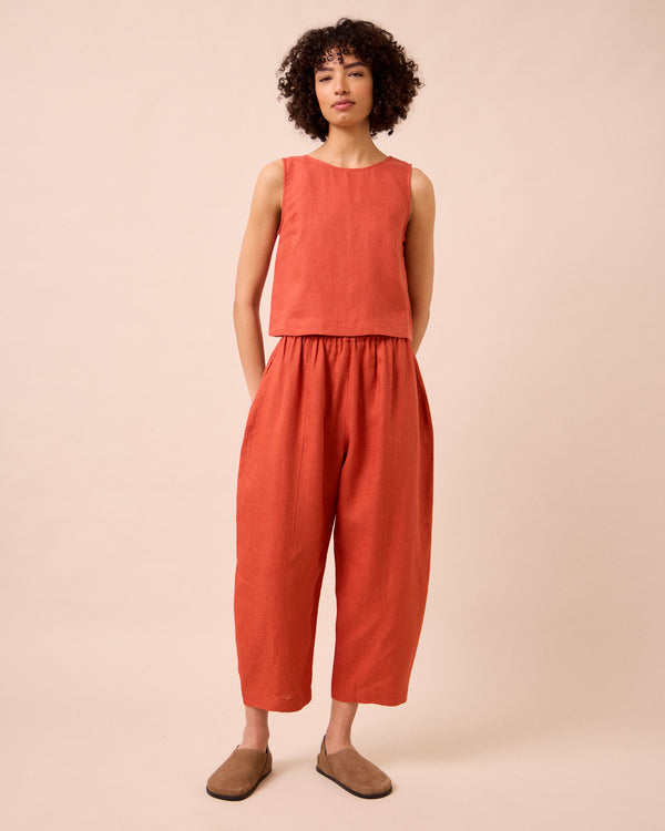 model wears esme burnt orange linen top
