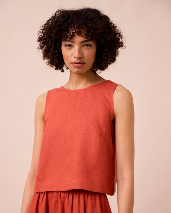 model wears esme burnt orange linen top