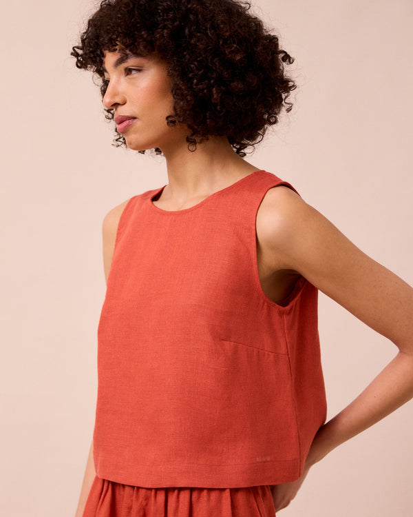 model wears esme burnt orange linen top