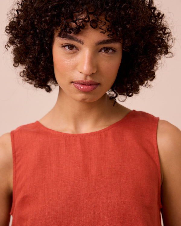 model wears esme burnt orange linen top
