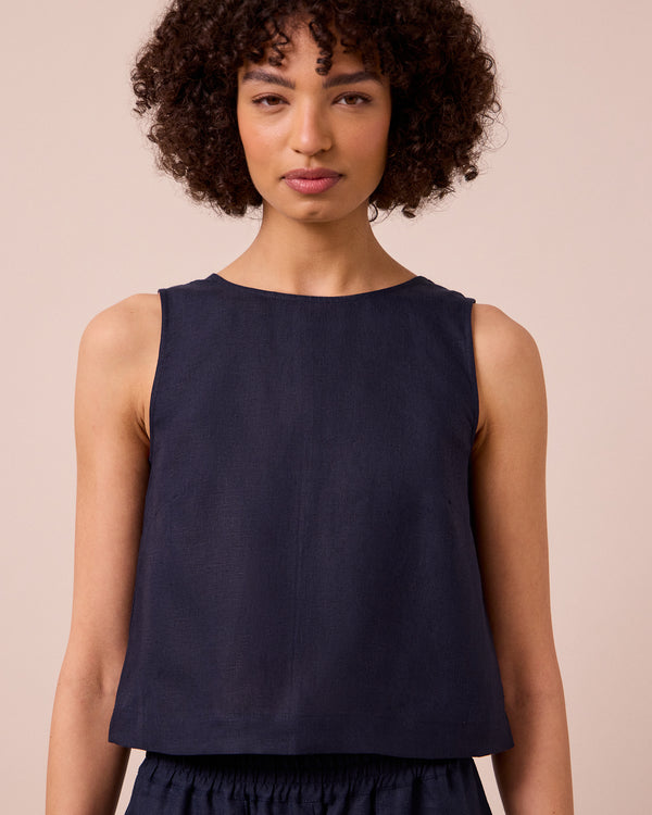 model wears esme navy linen top